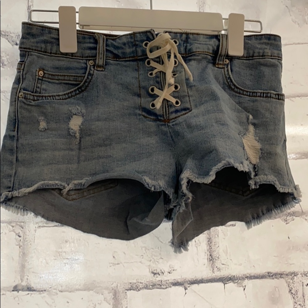 Ripped denim jeans with corset tie up front
